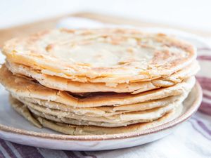 A stack of parathas on a plate.