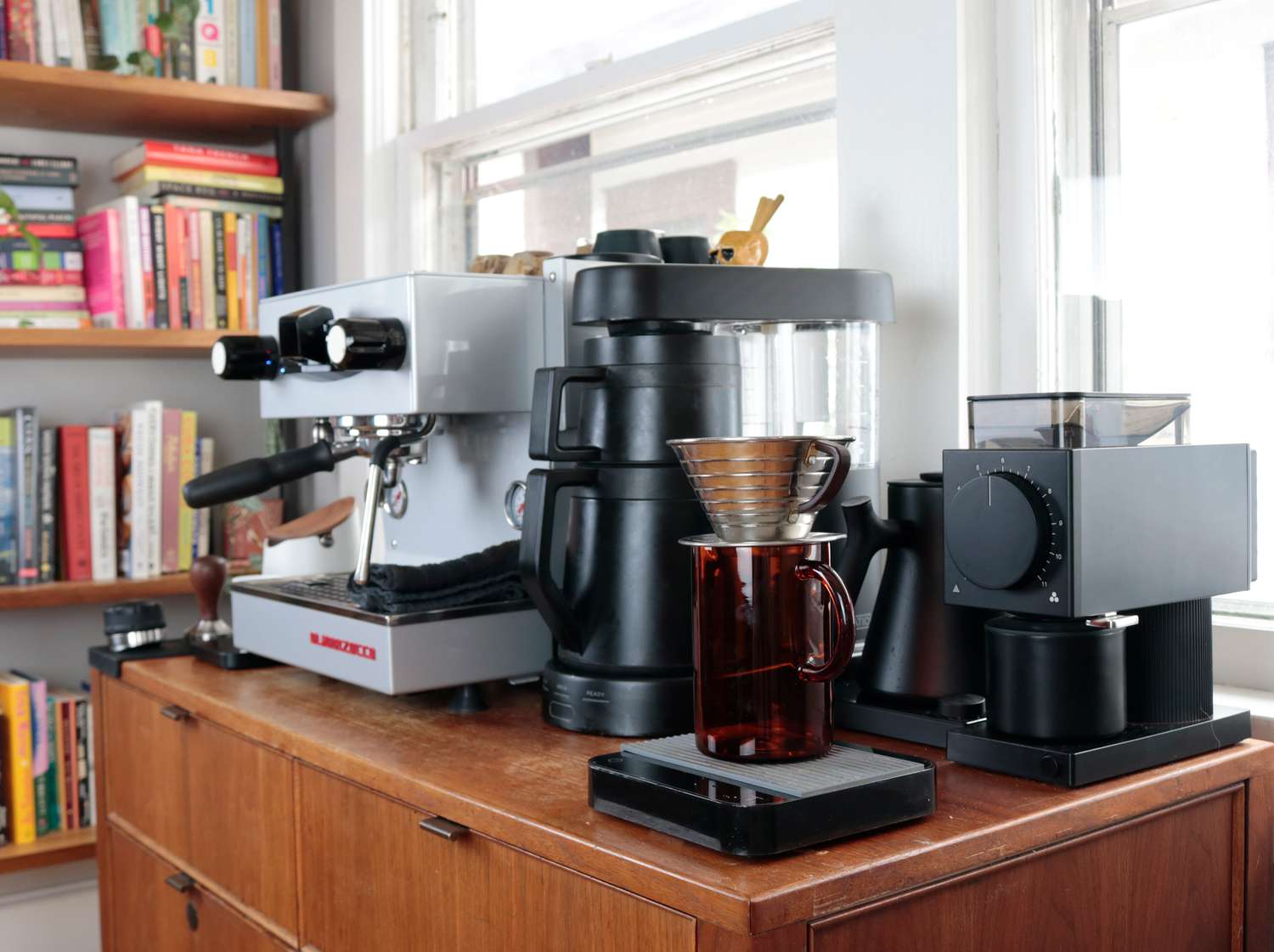 a coffee bar viewed from the side with a coffee grinder prominently featured on the right