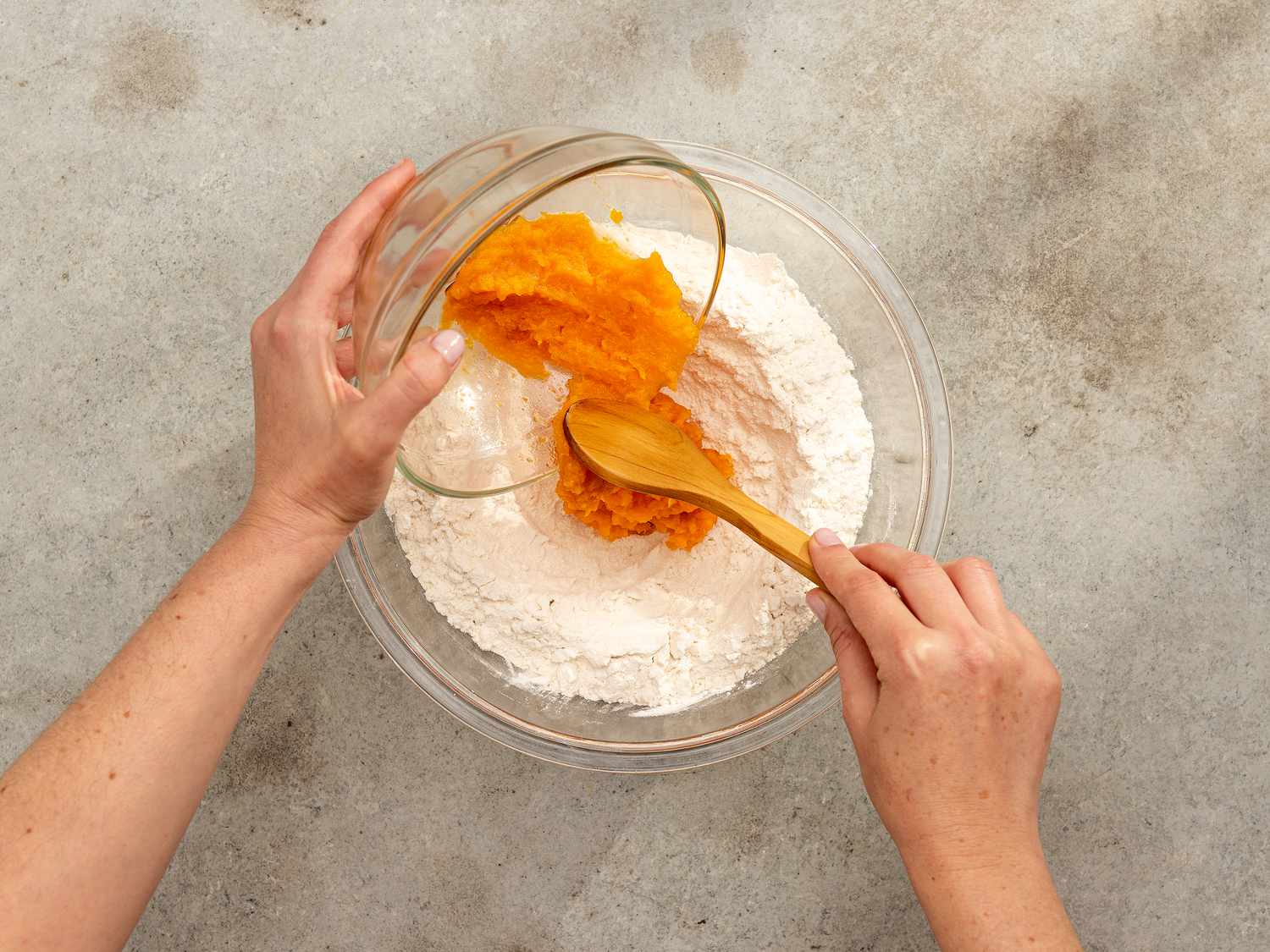 Overhead view of adding squash to flour mixture