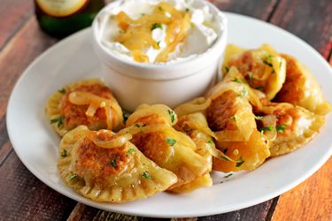 philly cheesesteak pierogi plated with creamy dip