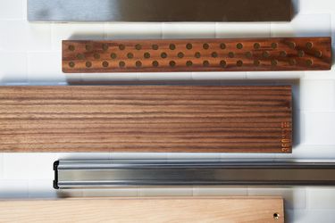 a group of magnetic knife bars against white subway tile