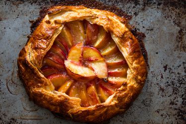Overhead of a freeform peach galette with golden brown crust