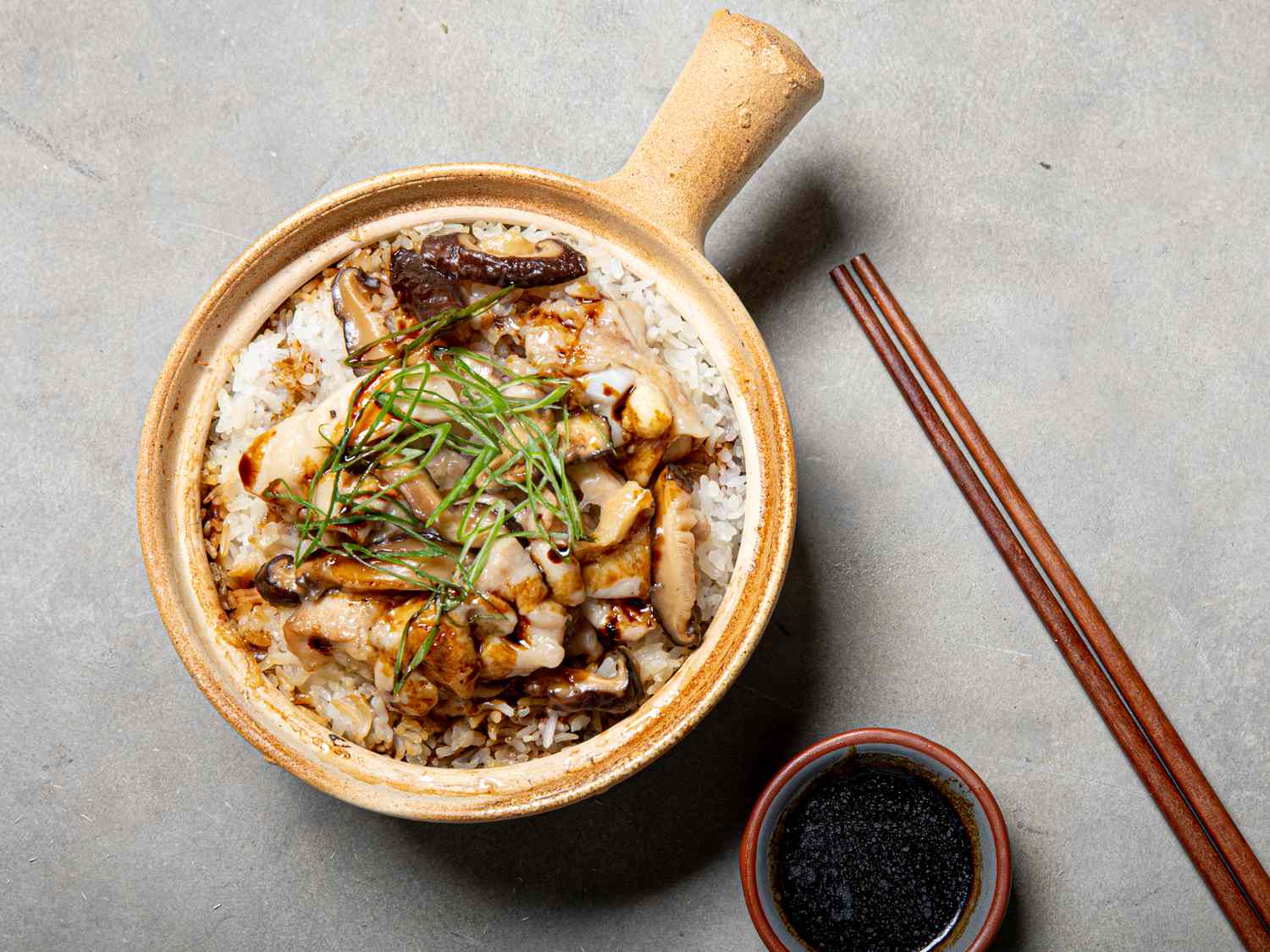 Velveted chicken and mushrooms on top of Cantonese clay pot rice.