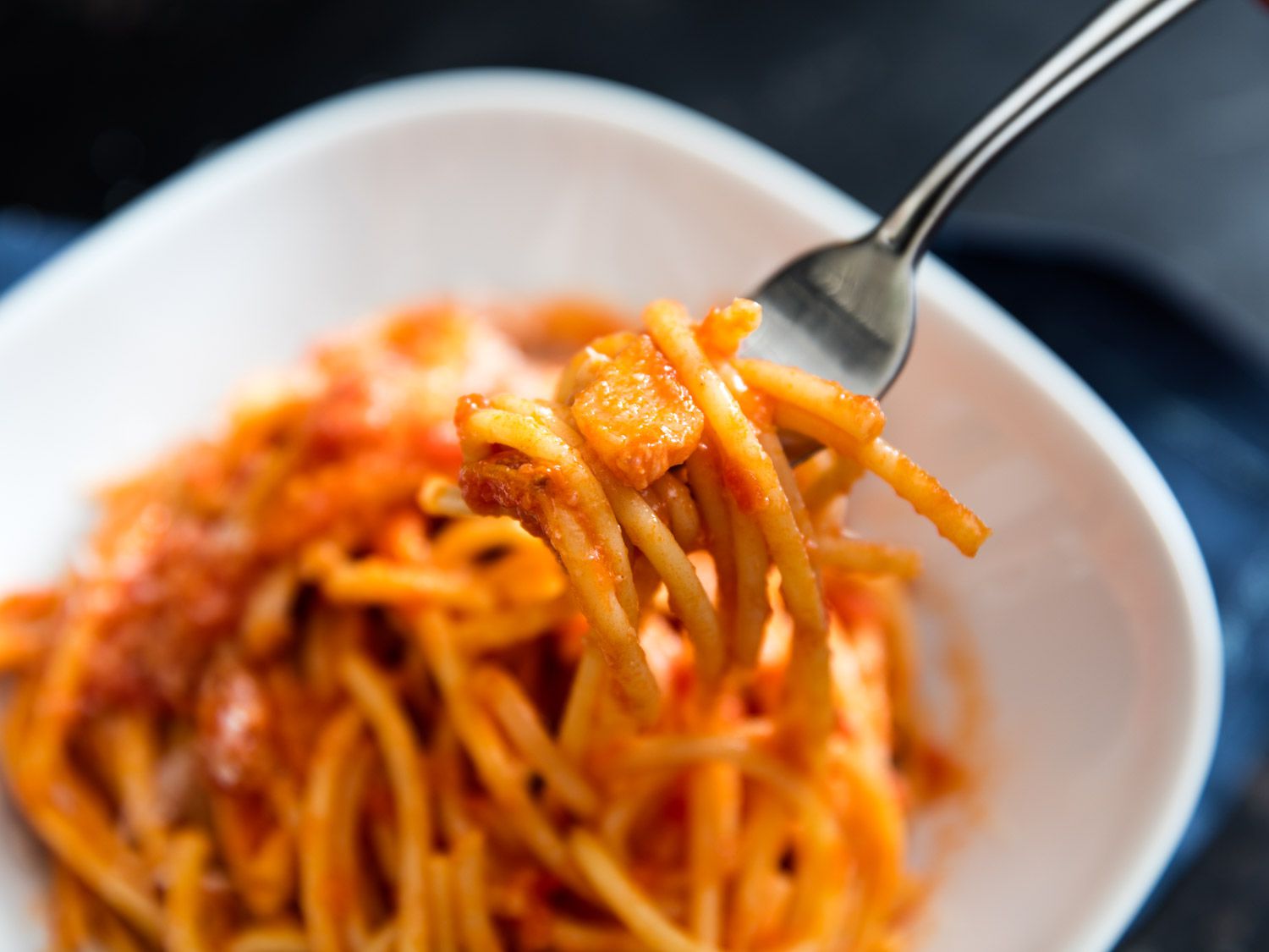 Close-up of a bite of bucatini all'amatriciana.
