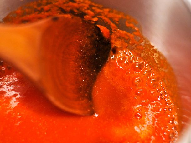 Reducing homemade sriracha in a saucepan.