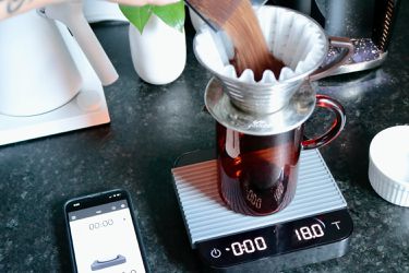 Pouring coffee into pourover maker sent on the Acacia Pearl scale