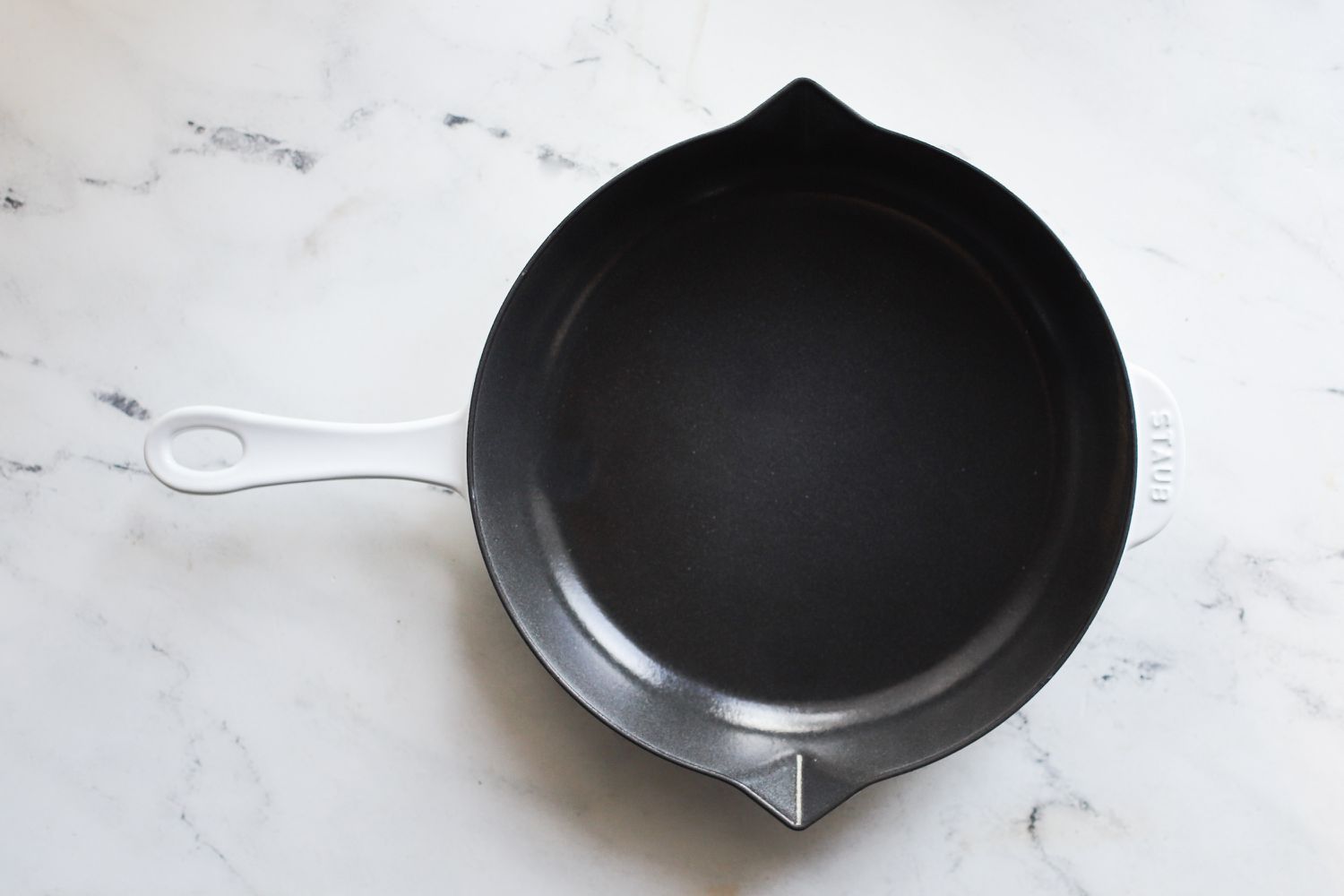 staub skillet on marble countertop