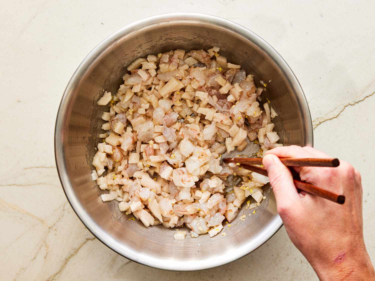 Overhead view of mixing shrimp mixture