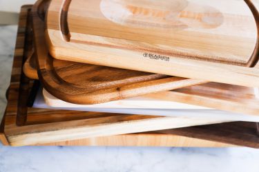 A stack of carving boards on a marble surface