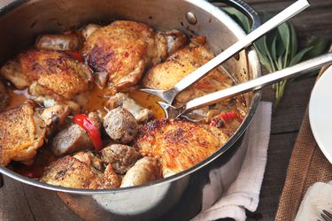 A pan of chicken scarpariello (braised chicken with sausage and peppers)