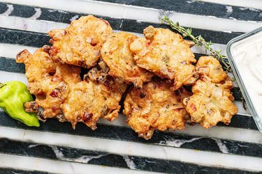 Savory fritters served with herbs and peppers.