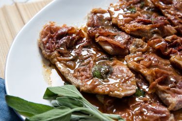 Veal saltimbocca in pan sauce, garnished with fresh sage