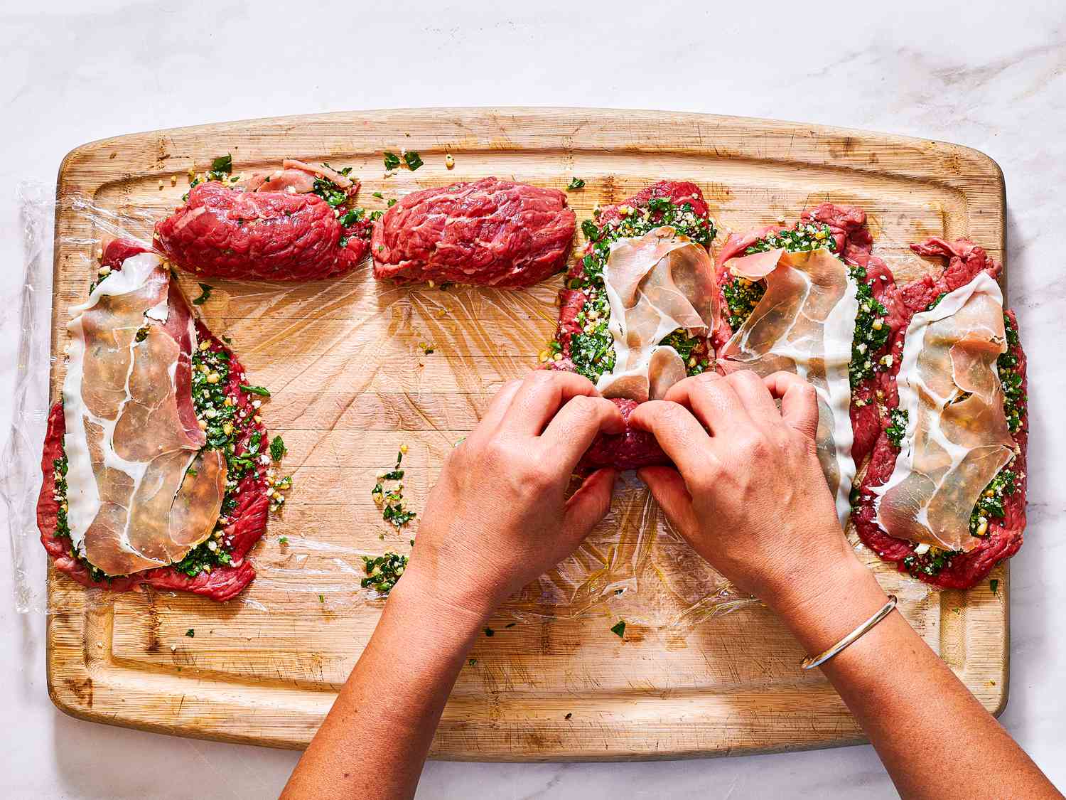 Rolling individual bundles of beef Braciole