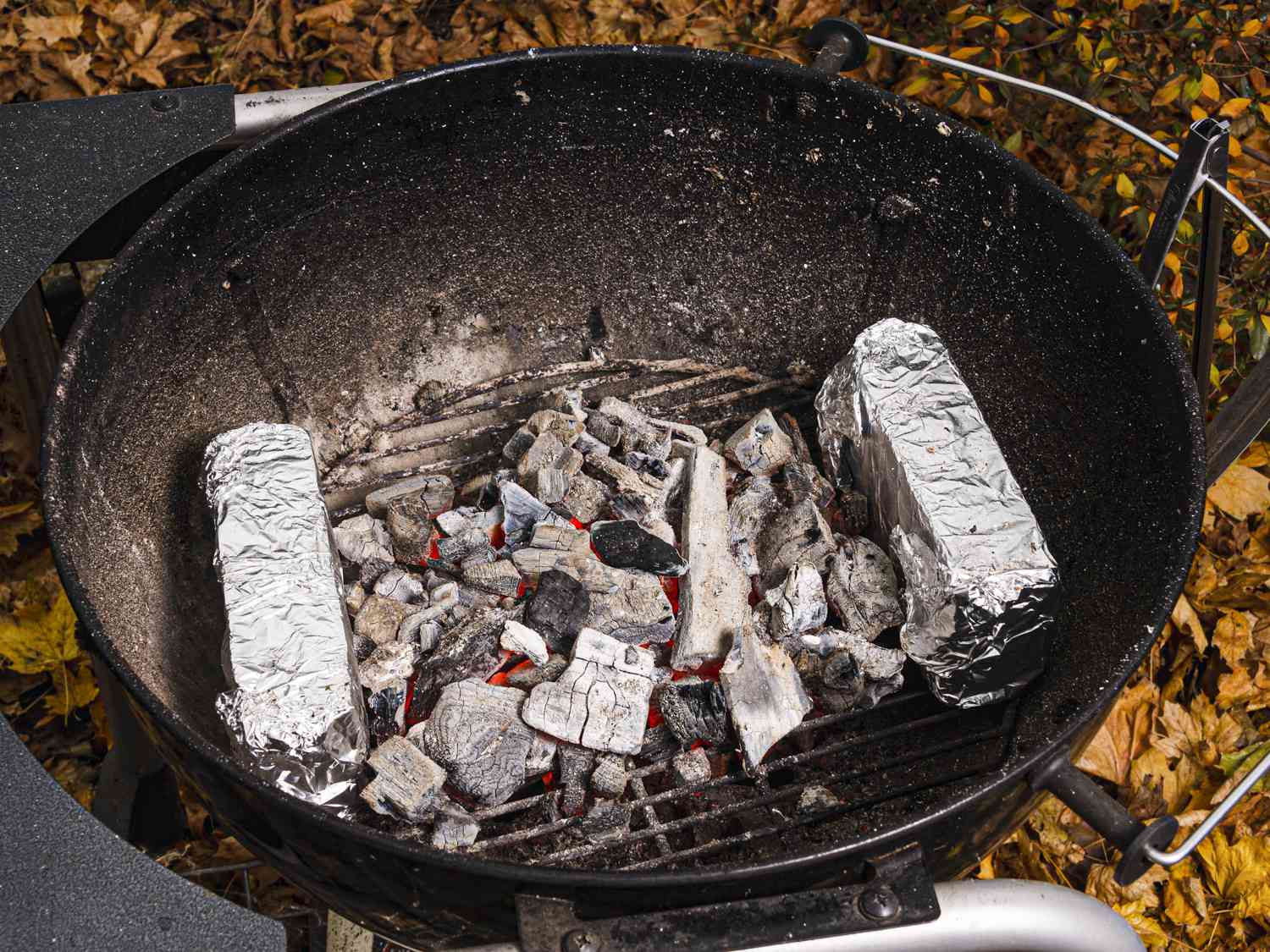 Overhead view of a charcoal grill setup for skewers