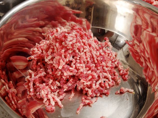 一碗搅拌碗，里面放着一堆粗碎的牛肉。