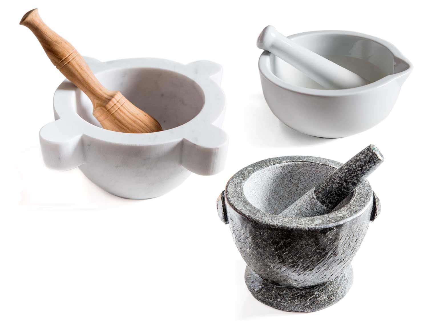 Three large mortars and pestles in marble, granite, and ceramic