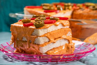 Side view of a piece of Pastel de Atun on a festive pink plate