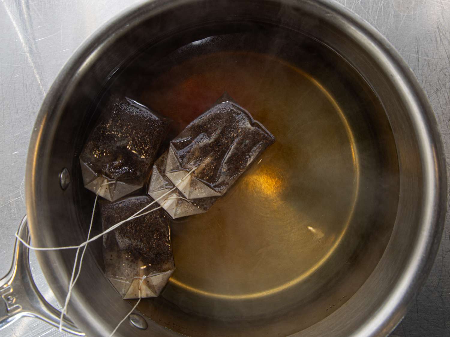 Overhead view of tea brewing in a pot