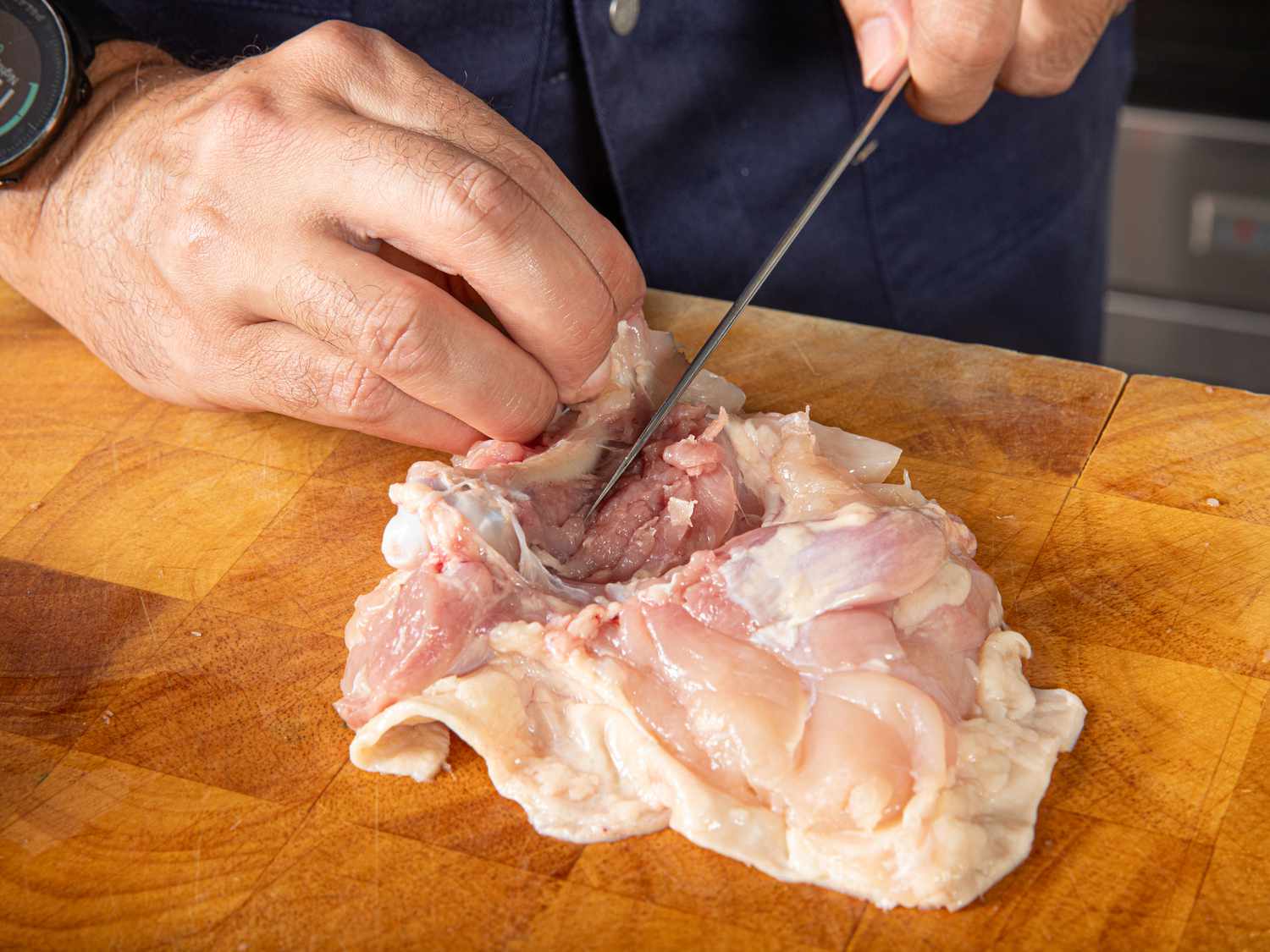 Overhead view of cutting meat away from the bone