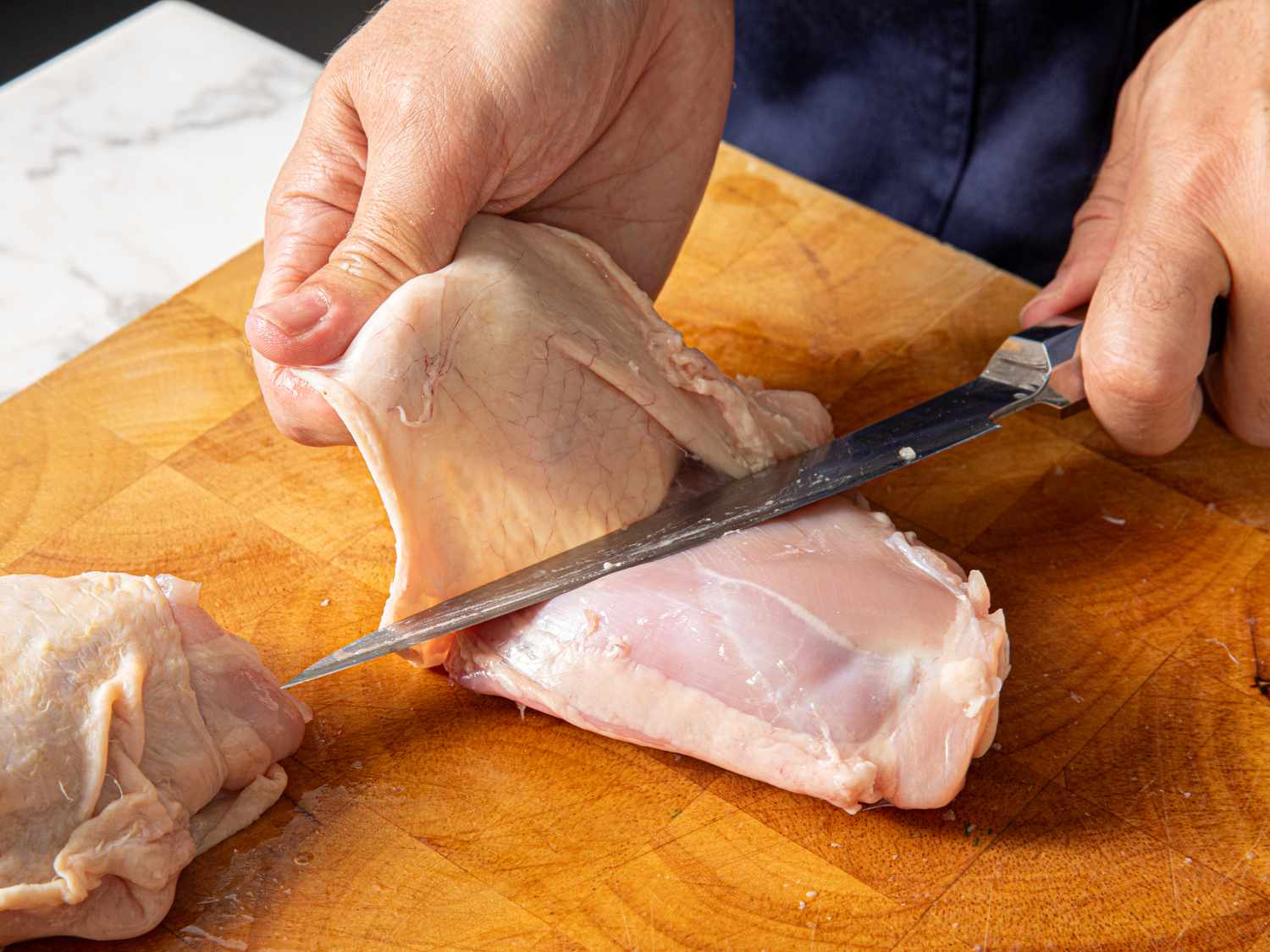 Removing skin from a Chicken thigh