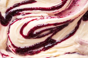 Close-up of ice cream swirled with thick fruit syrup
