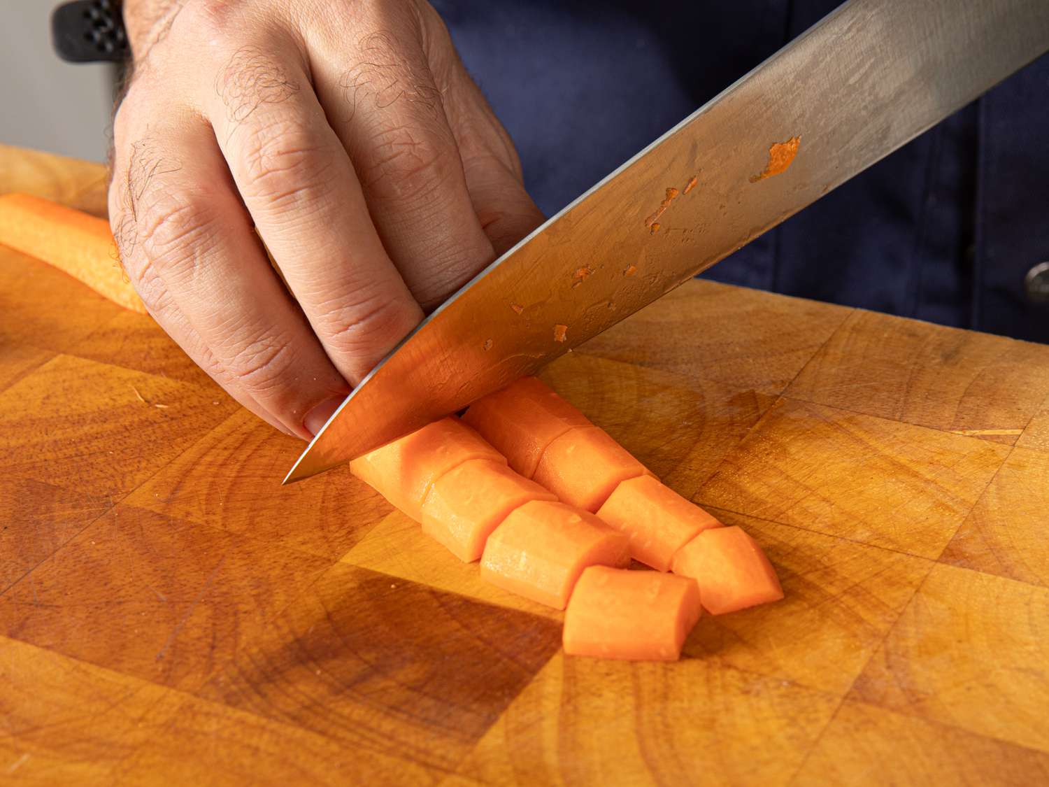 Overhead view of cutting carrots into smaller pieces