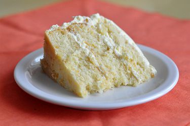 A slice of pig pickin' cake, served on white dessert plate.