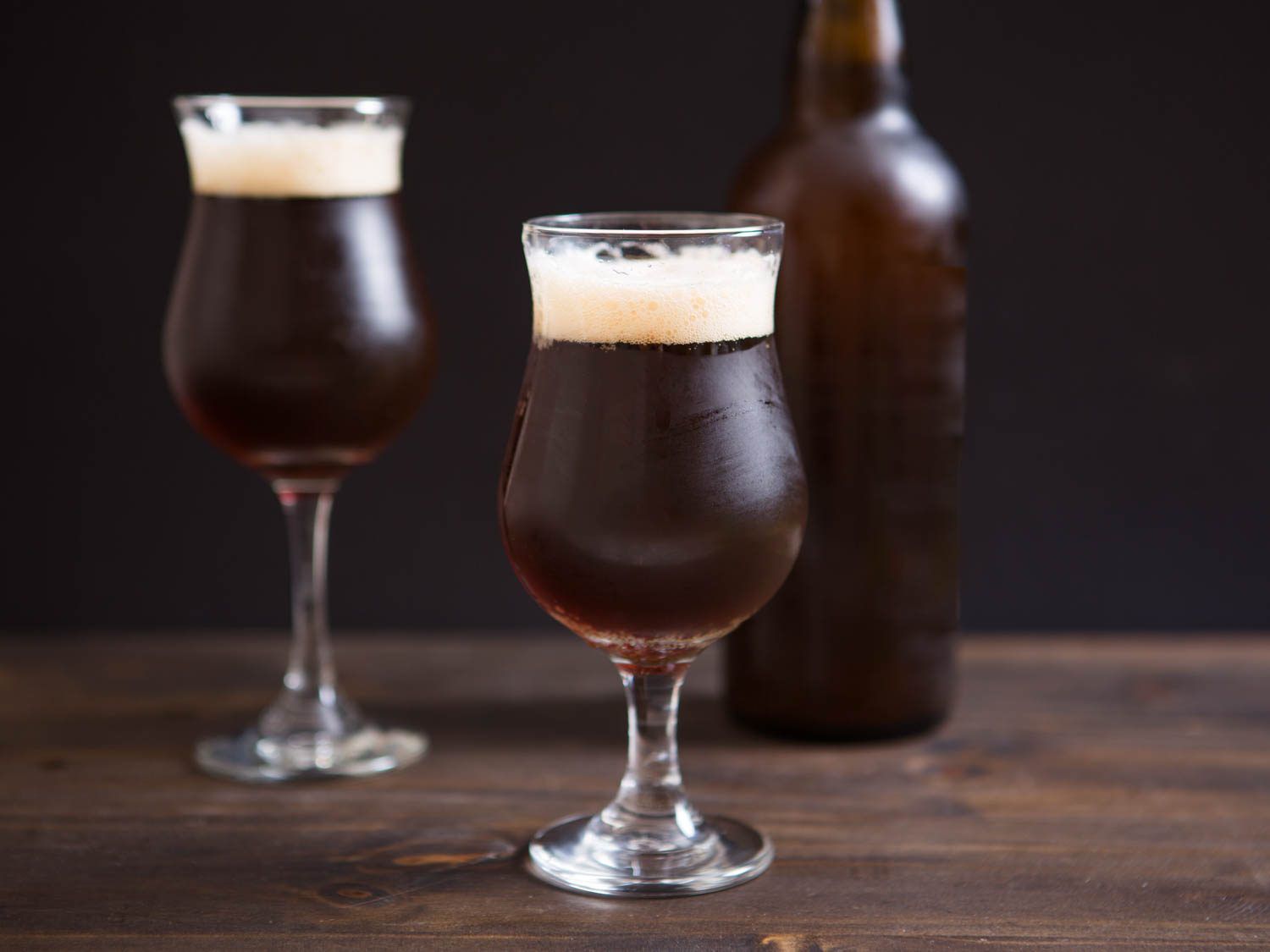 Beer in two stemmed beer glasses.