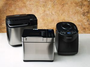 three bread machines lined up on a counter