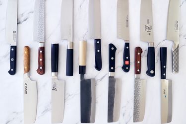13 nakiri knives on a marble countertop