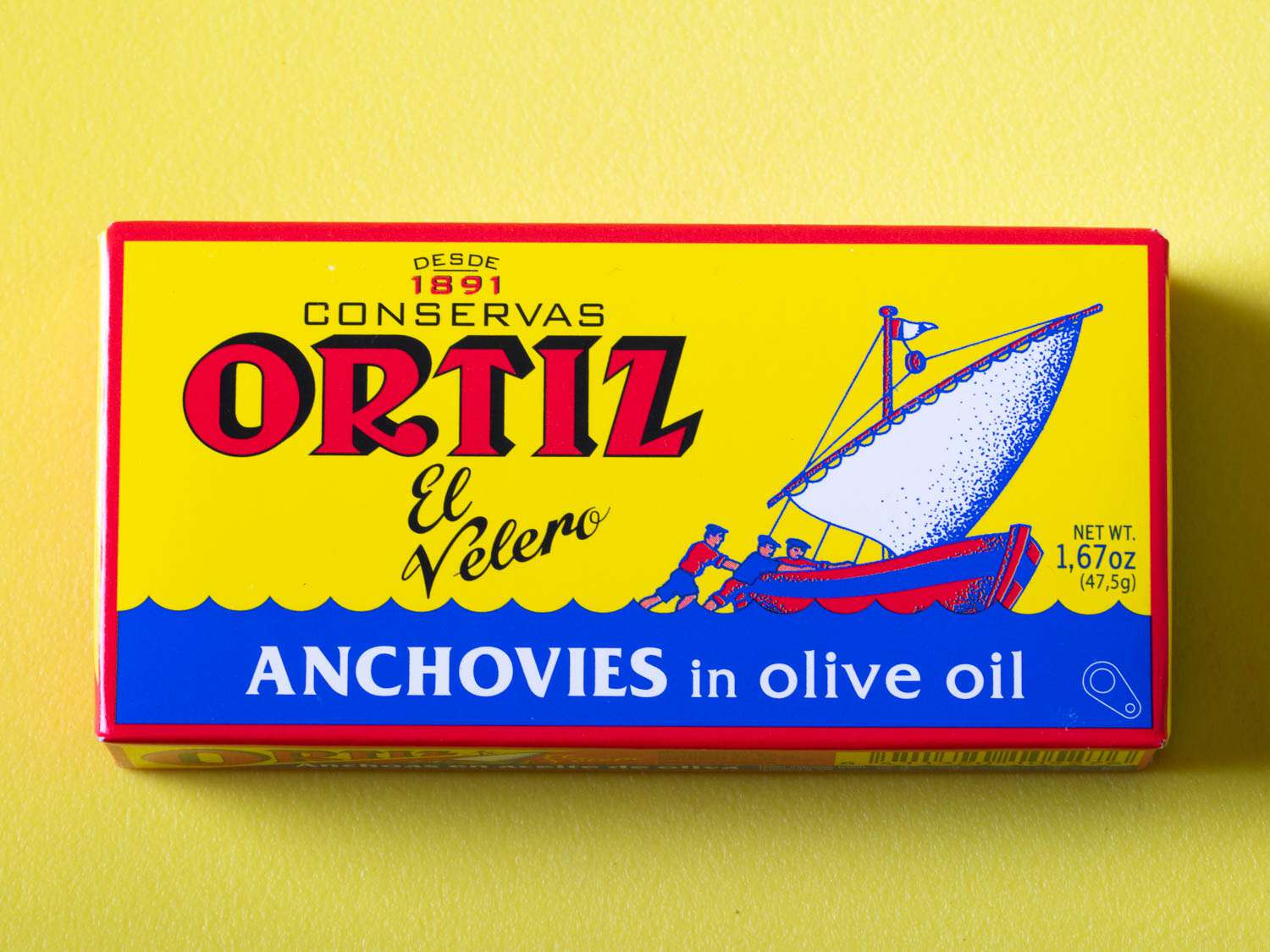 包装的ortiz anchovies on a yellow background.