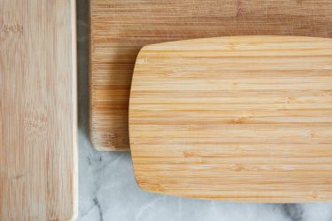 three wooden cutting boards on a marble surface