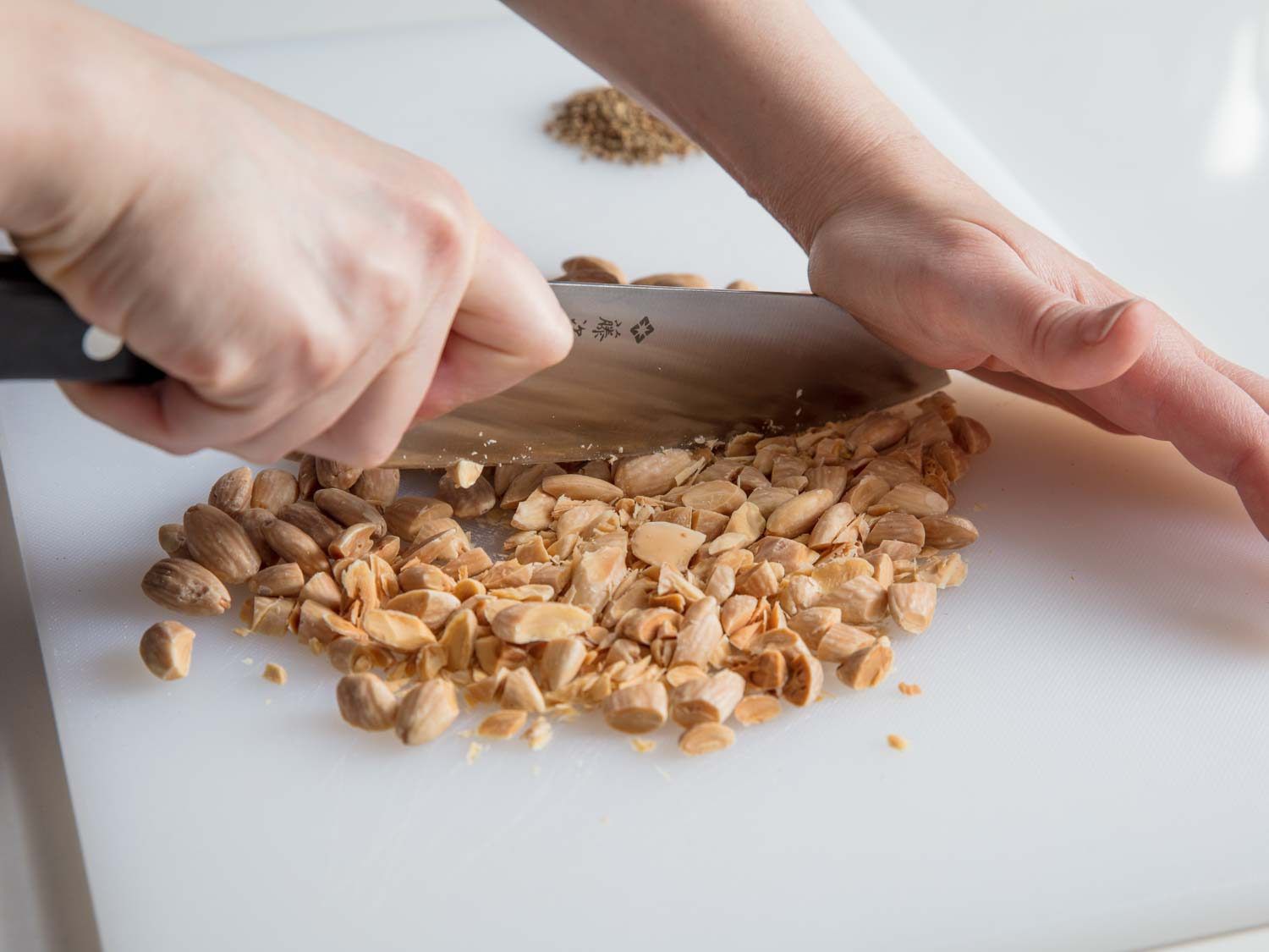 Chopping toasted almonds.