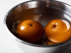 Frozen pears thawing in bowl of water