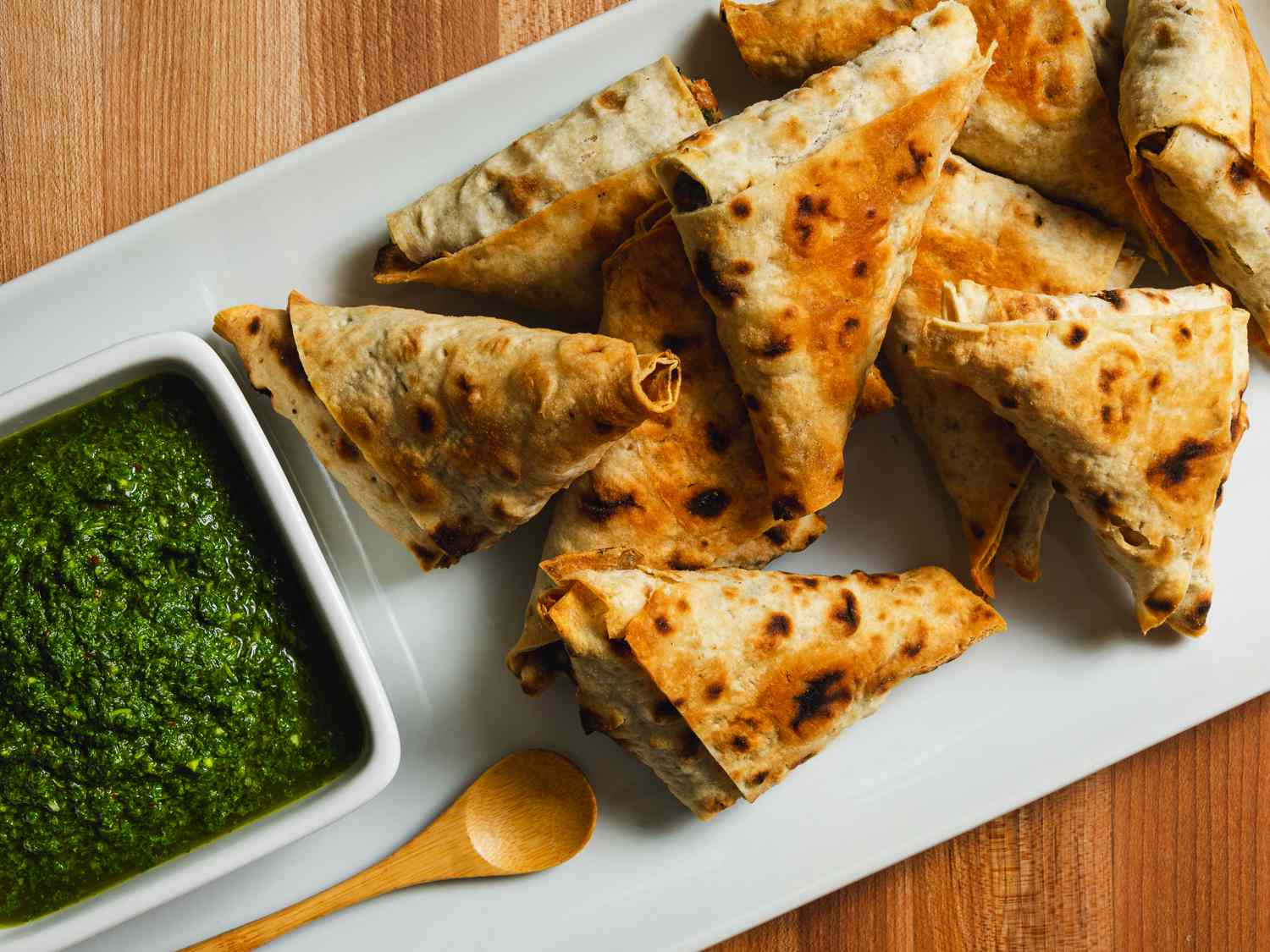 Lavash triangles on a serving platter with dipping sauce.