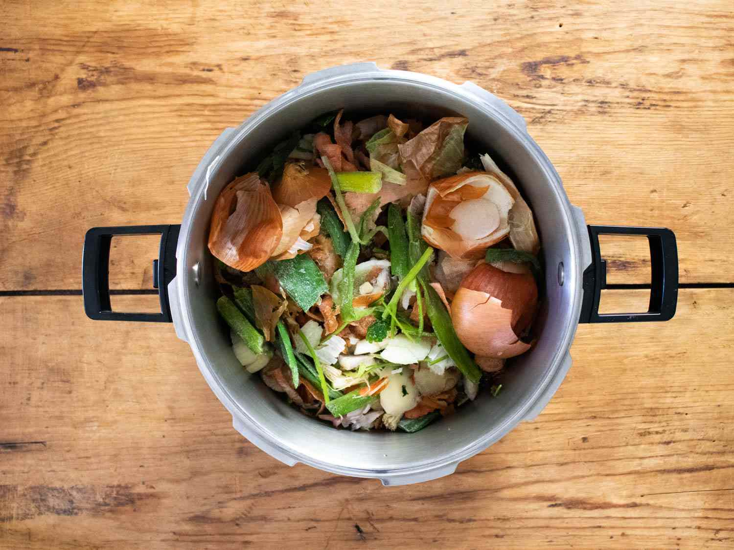 Frozen vegetable scraps in a large pot.