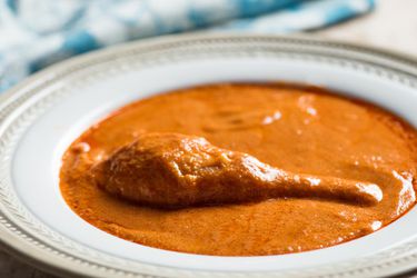 A bowl of Ghanaian Chicken and Peanut Stew (Groundnut Soup)